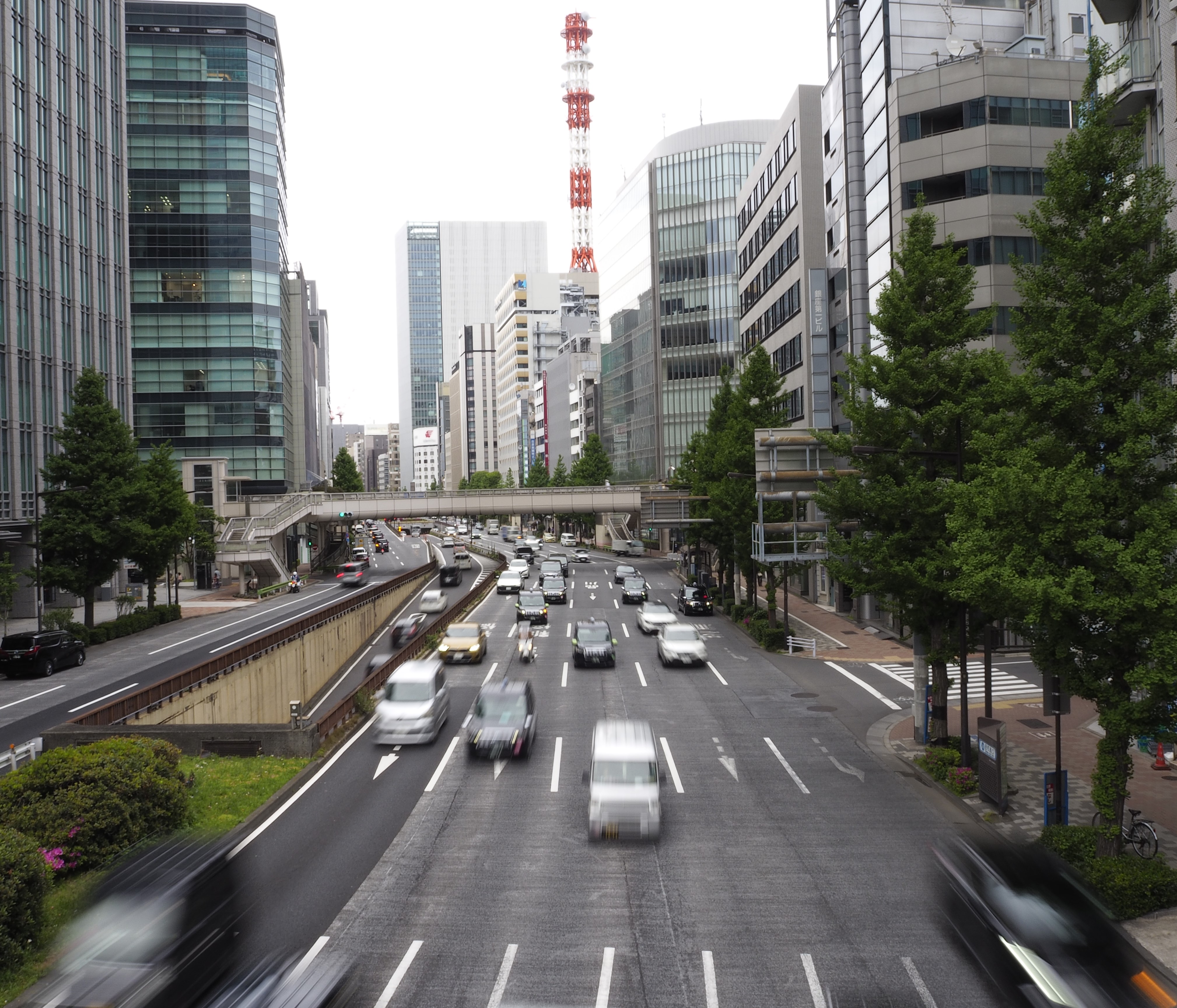 cars driving under a bridge